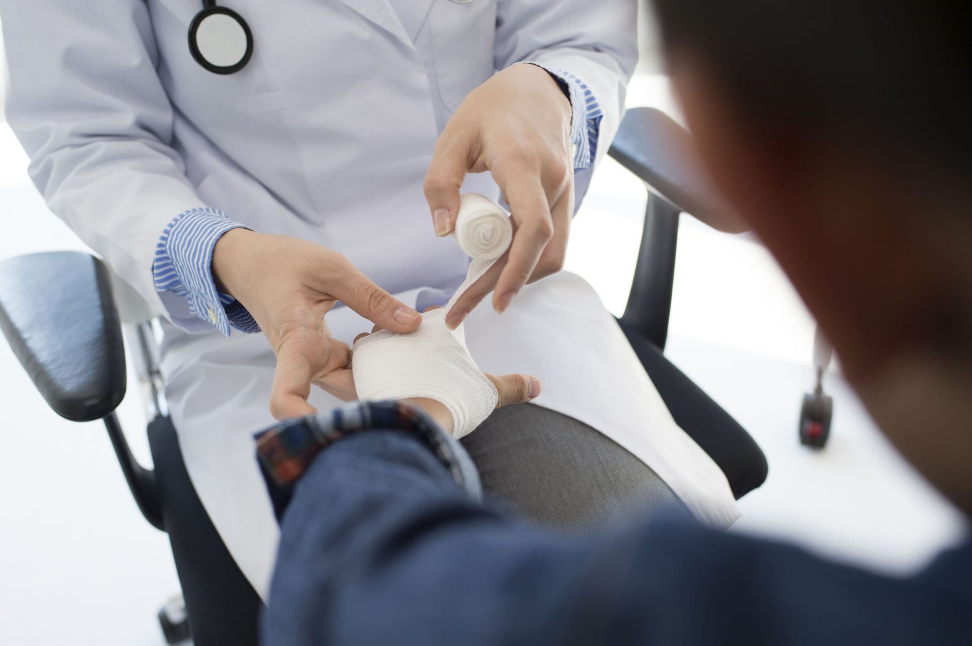 guys-hand-getting-wrapped-by-bandage